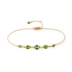 Five graduated oval cut apple green peridot framed in a halo of 14 karat yellow or white gold are suspended from a delicate chain to form this dainty bracelet. Perfect for layering or on its own for a subtle bit of sparkle. Gently clean with mild soap and water with a soft brush.  Can be cleaned with an ultrasonic or steam cleaner as well. Peridot Bracelet, Turquoise Hoop Earrings, Dainty Bracelet, Forever Jewelry, Delicate Chain, Jewelry Ring Box, Dainty Bracelets, Green Peridot, Men's Jewelry Rings