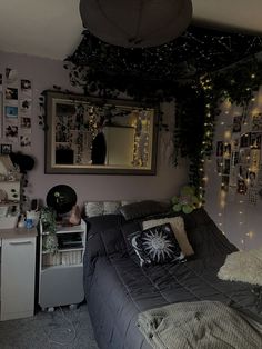 a bed room with a neatly made bed and lots of lights on the wall above it