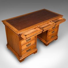 an old wooden desk with two drawers on one side and a drawer on the other