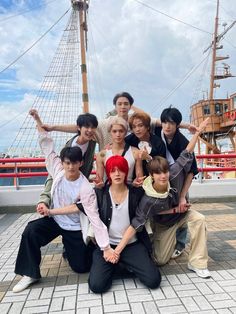 the group is posing for a photo in front of an old pirate ship at seaport