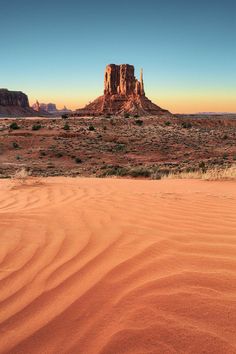 the desert with sand dunes and mountains in the background