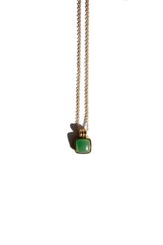 a necklace with a green stone hanging from it