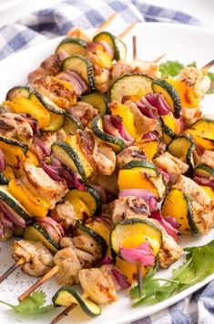 grilled chicken and vegetable kabobs on a white plate