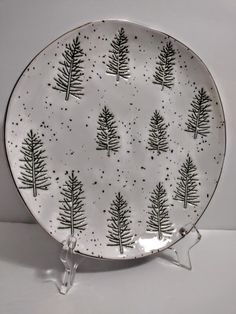 a white plate with black trees on it