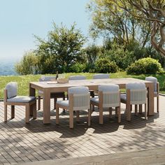 a wooden table with white chairs on top of it