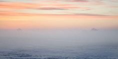 the sky is covered in thick fog as it sits on top of an ocean floor