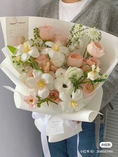 a woman holding a bouquet of flowers in her hands