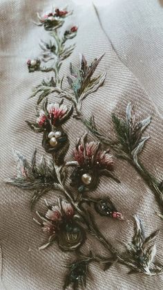 some flowers are growing on the side of a piece of cloth