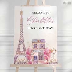 an easel with a sign that says welcome to charlotte's first birthday