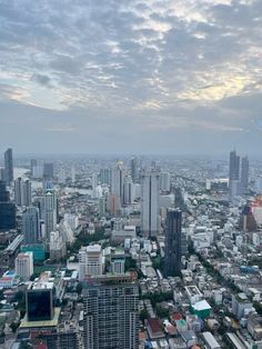 an aerial view of a city with tall buildings and skyscrapers in the foreground