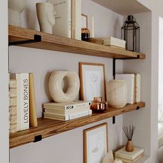 some shelves with books and vases on them