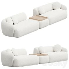 two white couches with pillows and a table in the middle one has a wooden tray on it