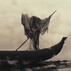 a man in a boat floating on top of the ocean with a cloth draped over his head