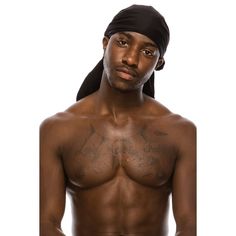 a man with no shirt on wearing a black turban and holding his hands in his pockets