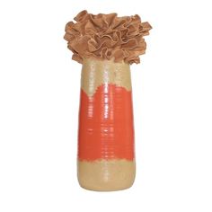 an orange and brown vase with ruffles on the top sits against a white background