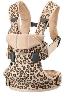 a baby carrier with leopard print on the front and back, one side facing forward