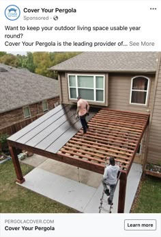 two men working on the roof of a house that is being built with wooden slats