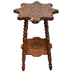 an old wooden table with carvings on the top and bottom, sitting against a white background