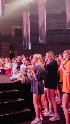 a group of people standing on top of a stage with microphones in their hands