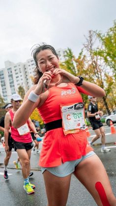 a woman in an orange shirt is running