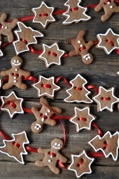 gingerbread cookies decorated with icing and red ribbon on a wooden table, ready to be eaten