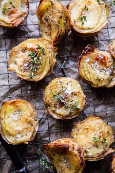 baked potatoes with herbs and cheese on a wire rack