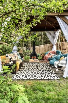 an outdoor living area with couches and chairs