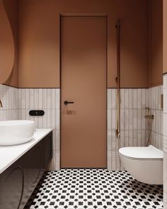 a white toilet sitting next to a bathroom sink