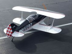 a small airplane sitting on top of an airport tarmac