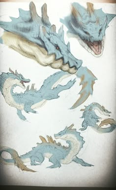 some blue and white dragon drawings on a piece of paper