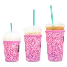 three plastic cups with straws and lids are lined up in the same row, one is pink