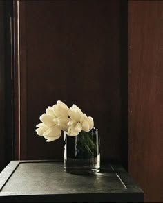 a glass vase with flowers in it on a table