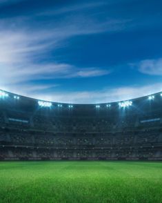 an empty soccer stadium with the lights on