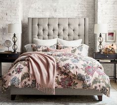 a bedroom with white brick walls and furniture