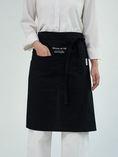 a woman wearing an apron and white shirt