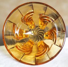 an orange glass object sitting on top of a table