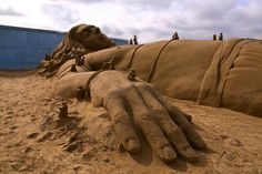 sand sculptures made to look like human hands