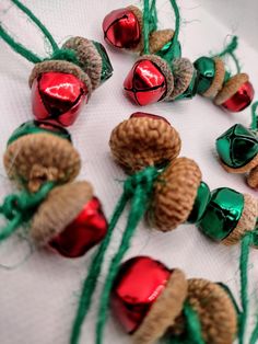 some pine cones are wrapped in twine and decorated with christmas ornaments