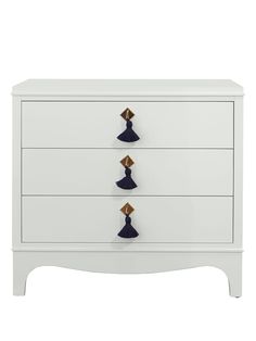 a blue dresser with three drawers and two knobs on the top, in front of a white background