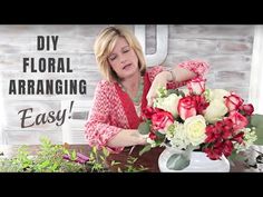 a woman arranging flowers in a vase on top of a table with the words diy floral arranging easy