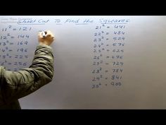 a person writing on a white board with numbers