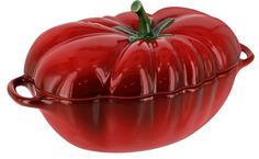 a large red tomato sitting on top of a white table