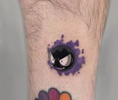 a man's leg with a cartoon character tattoo on the side of his foot