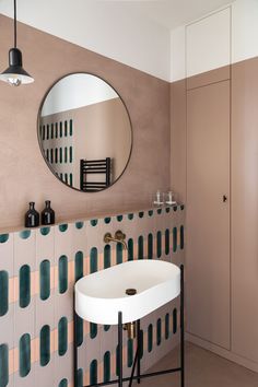 a bathroom with a sink, mirror and cupboards in front of the wallpaper