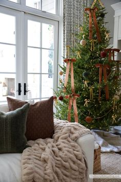 a living room with a christmas tree in the corner