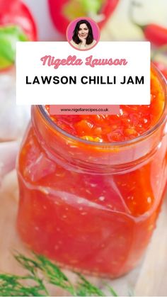 a jar filled with red sauce sitting on top of a table