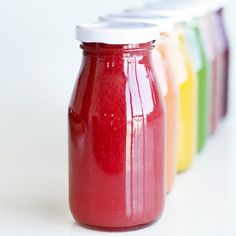 there are four jars with different colored liquids in them