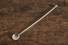 a spoon sitting on top of a wooden table