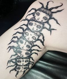 a woman's arm with tattoos on it and three faces in the shape of sunflowers