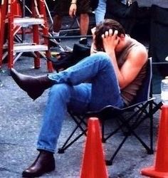 a man sitting in a chair talking on his cell phone